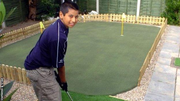 A young Rai practising on the putting green in his parents' back garden