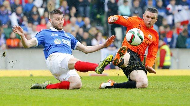 Stephen Lowry and Andy Kilmartin contend for possession during the first half at Windsor Park