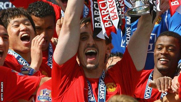 Gary Neville lifts the Premier League trophy for Manchester United