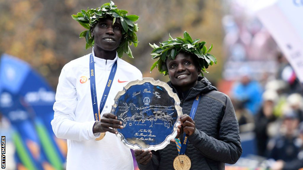 Kenyans Geoffrey Kamworor and Joyciline Jepkosgei on the podium after winning the men's and women's marathons in New York in 2019