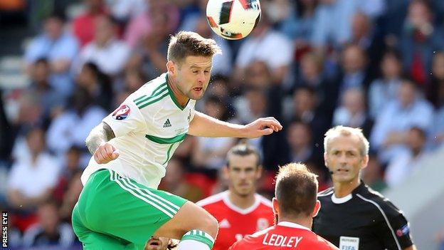 Oliver Norwood sends in a header against Wales in the Euro 2016 finals