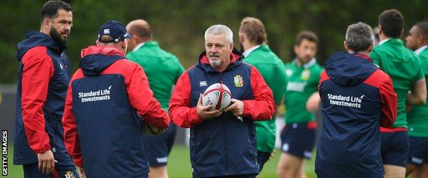 Lions coach Warren Gatland talks with his backroom staff during a training session in Wales