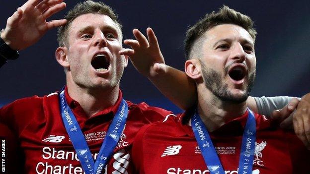 James Milner (left) and Adam Lallana celbrate winning the Champions League title in 2019