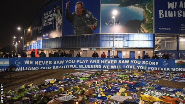 Tributes to striker Emiliano Sala have been laid by supporters at Cardiff City Stadium