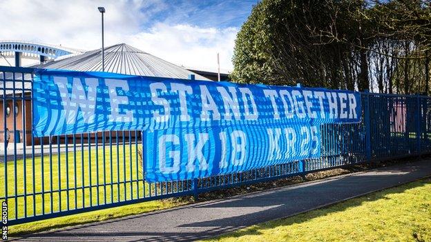 Rangers fans leave a banner at the club's training ground in support of Glen Kamara and Kemar Roofe