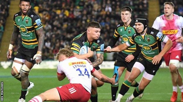 Northampton flanker Aaron Hinkley (centre) being tackled