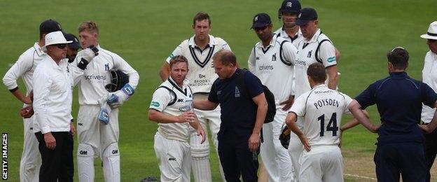 Ian Westwood receives treatment after being hit on the shoulder by a shot from Dawid Malan while fielding at short leg