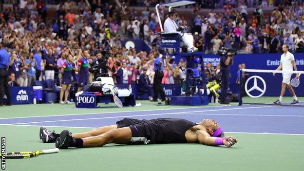 Rafael Nadal falls to the ground after winning