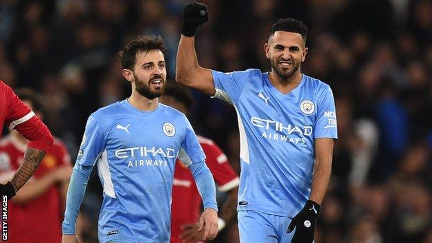 Bernardo Silva and Riyad Mahrez (right) celebrate a goal for Manchester City