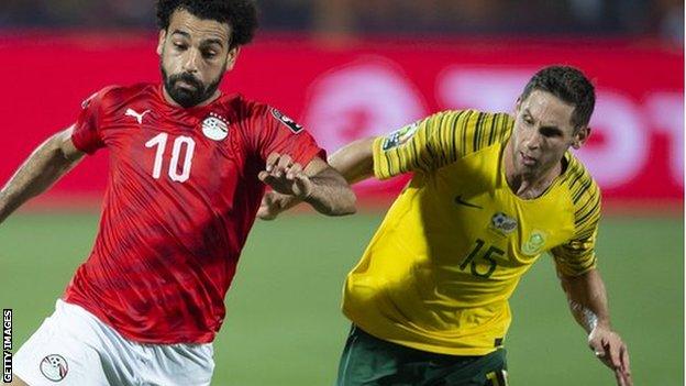 Dean Furman of South Africa (right) challenges Egypt's Mo Salah