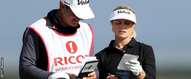 Carly Booth consults her caddie during the Women's British Open at Kingsbarns