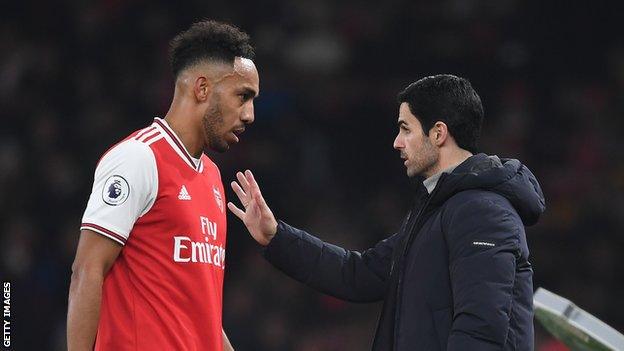 Arsenal captain Pierre-Emerick Aubameyang (left) speaks to manager Mikel Arteta (right) during a match