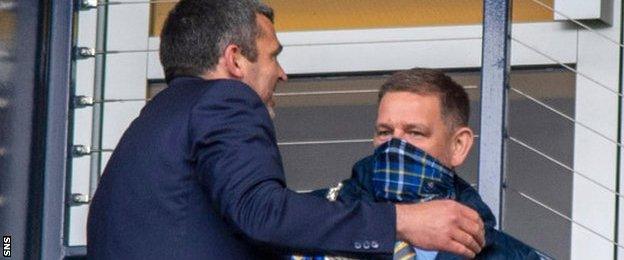 St Johnstone manager Callum Davidson shows Steve Brown the Scottish Cup