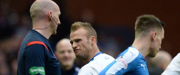 Referee Bobby Madden and Kilmarnock midfielder Kallum Higginbotham