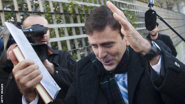 Spanish doctor Eufemiano Fuentes tries to avoid the media at his trial in Madrid in January 2013