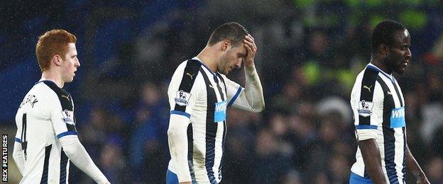 Newcastle players leave the pitch after their defeat