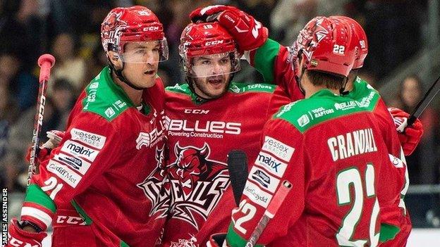 Cardiff Devils' Jake Coughler celebrates with team-mates after scoring against Glasgow Clan