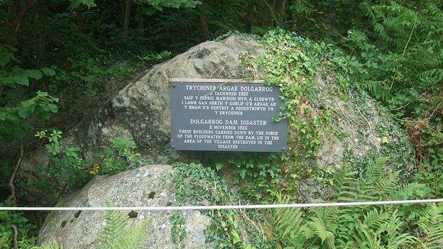 A memorial plaque on the boulders brought down in the flood