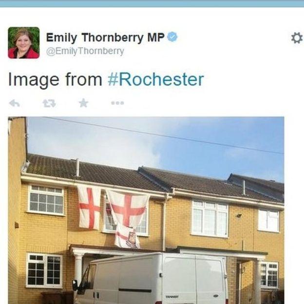 Three St George's flags and a white van