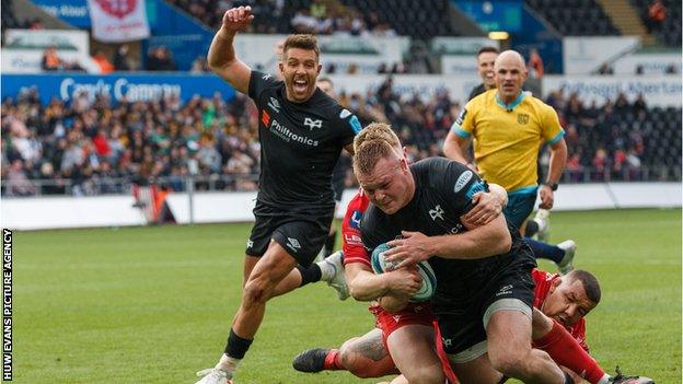 Ospreys celebrate scoring Dewi Lake's second try against Scarlets