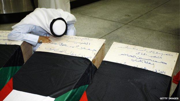 A Kuwaiti man mourns over the coffin of a relative, who lost his life during the attack on a mosque in Kuwait City that killed at least 27 people on Friday.