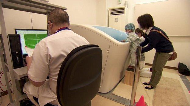 Myuki Arakawa and one of her sons at the hospital test facility