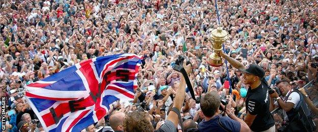 Lewis Hamilton of Great Britain and Mercedes GP celebrates with the fans after winning the Formula One Grand Prix of Great Britain at Silverstone Circuit on July 5, 2015