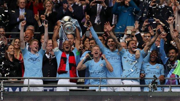 Man City captain Vincent Kompany lifting the FA Cup in Wembley's Royal Box