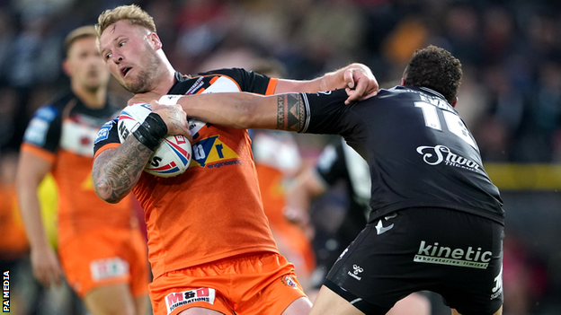 Castleford's Joe Westerman (left) is tackled by Hull's Kane Evans at the MKM Stadium