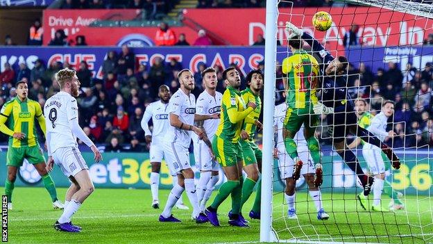 Craig Dawson beats a full-stretch Erwin Mulder to level for West Brom at Swansea