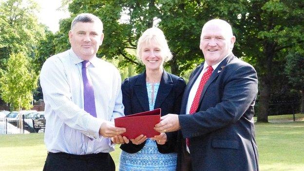 Council Leader Mark Pritchard, Chief executive Helen Pater and armed forces champion David Griffiths