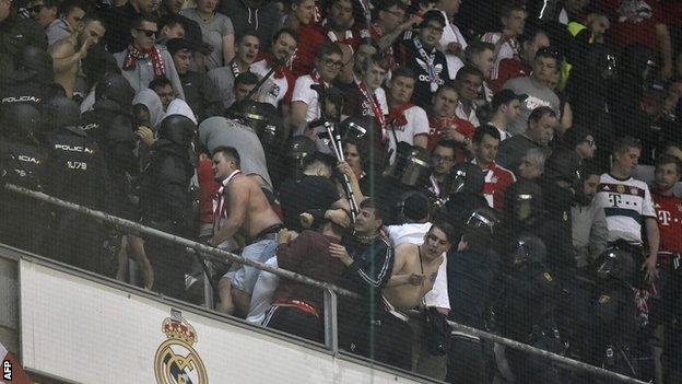 Spanish riot police clashed with Bayern Munich fans during the Champions League quarter-final at Real Madrid on 18 April