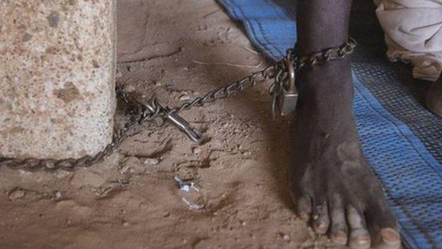 A man chained to a tree