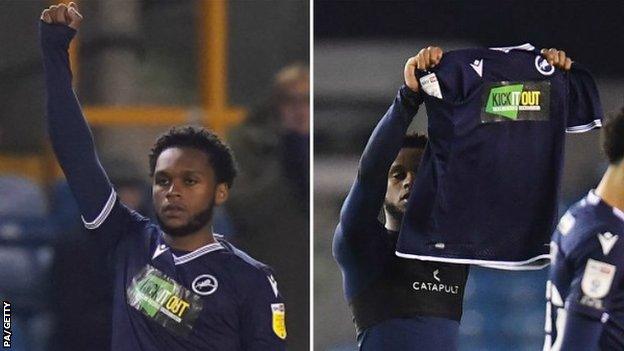 Millwall defender Mahlon Romeo raising a fist then his shirt - sponsored by Kick It Out - before and after his side's game with QPR