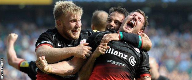 Jackson Wray and Neil de Kock celebrate with Alex Goode after the full-back's late try against Exeter