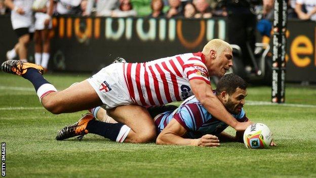 Ryan Hall and Greg Inglis compete for the ball during their match in 2014