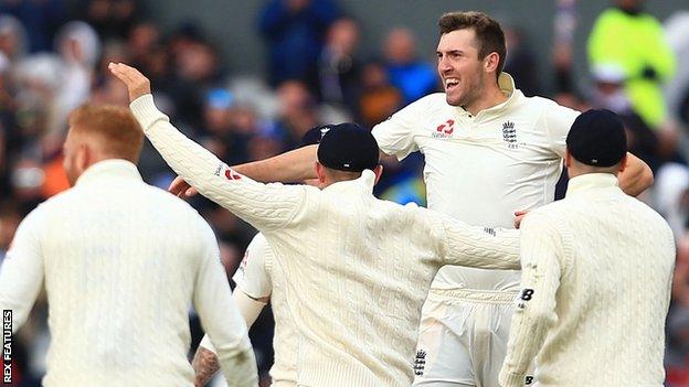 Craig Overton celebrates a wicket