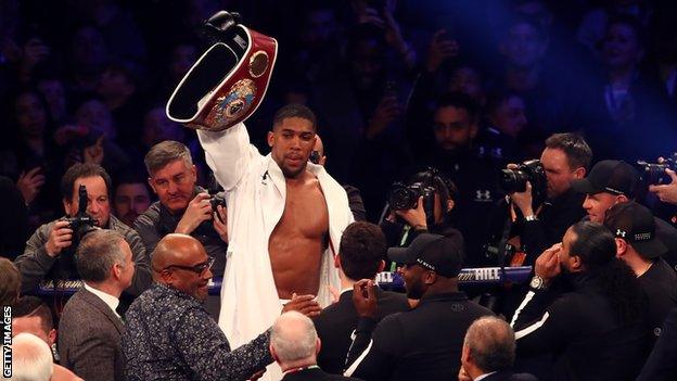 Anthony Joshua celebrates beating Joseph Parker to unify the WBA, IBF and WBO heavyweight titles