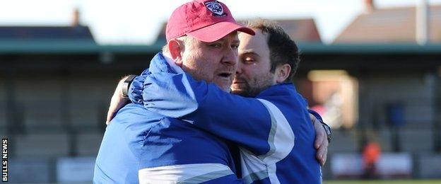 Peter Beadle is congratulated at the final whistle by Bulls physio Jonny Evans