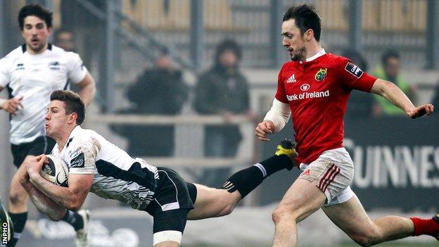 Zebre's Kayle Van Zyl is chased by Munster's Darren Sweetnam