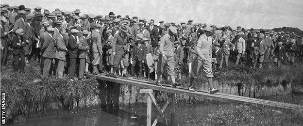 Macdonald Smith crosses the burn at Prestwick Golf Club in Scotland, during the Open Golf Championship , 26th June 1925