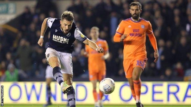 Tom Bradshaw unleashes a shot to bring Millwall level for the second time against Cardiff