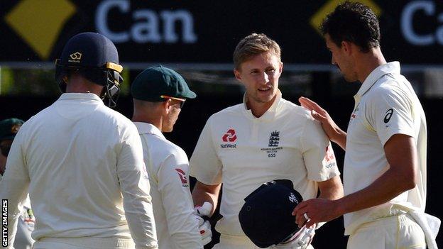 Australia's Mitchell Starc checks on Joe Root after hitting the England captain on the head with a bouncer