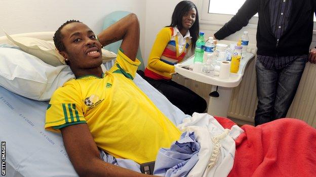 Togo's goalkeeper Kodjovi Obilale was one of those injured - pictured here with friends at Lorient hospital in France on 14 March 14, 2010