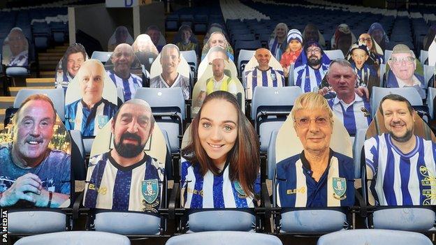 Cardboard cut outs of Sheffield Wedneday fans