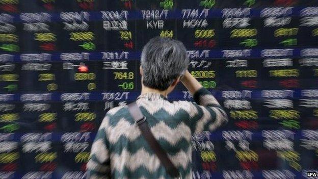 Woman looking at Japan share board