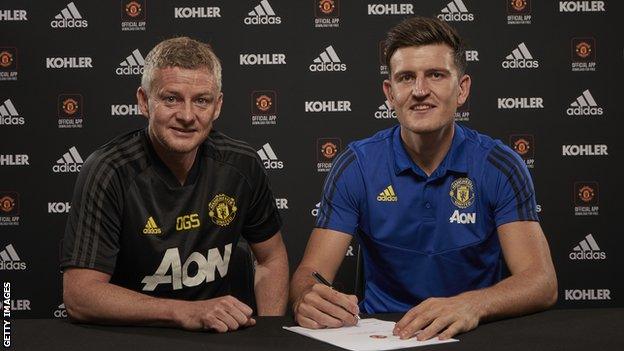 Harry Maguire pictured with Manchester United manager Ole Gunnar Solskjaer