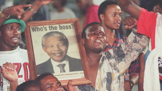 South Africa fans hold up a portrait of Nelson Mandela in the stands