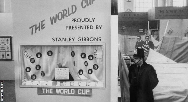 A policemen stands by a display case where the World Cup was stolen from