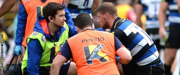 Rhys Priestland receives treatment after taking a knock playing for Bath against Scarlets